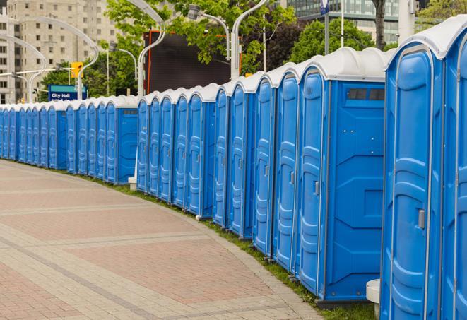 a row of portable restrooms at an outdoor special event, ready for use in Allston, MA